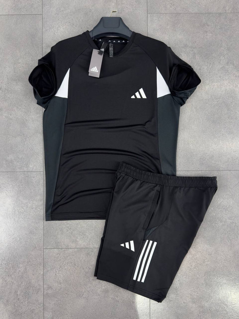 Prémium minőségű Adidas férfi szett, amely rövidnadrágból és egy fekete, fehér csíkos pólóból áll.